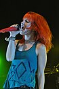 Hayley Williams singing onto a red mic