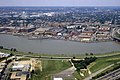 Aerial photograph of the Washington Navy Yard with a destroyer at dock, the Anacostia River in the foreground and Capitol Hill in the background.