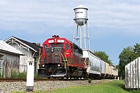 A local train of the Buckingham Branch railroad passes the C&O Depot and water tower in Louisa.