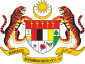 Shield showing symbols of the Malaysian states with a star and crescent above it and a motto below it supported by two tigers