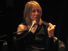 Suze Rotolo, speaking at a microphone