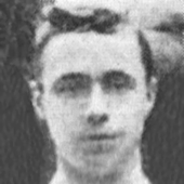 A black-and-white portrait photograph of a young man with short, dark-coloured hair.