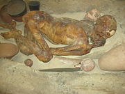 Mummified pre-dynastic man in reconstructed Egyptian grave-pit (photo taken in 2008)