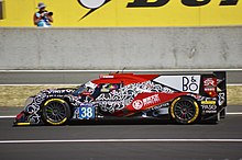 A red, black and white car