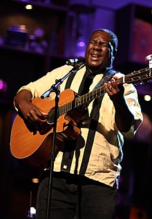 Musician playing guitar in concert