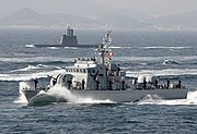 A Chamsuri-class patrol craft and a Sohn Wonyil-class submarine on background