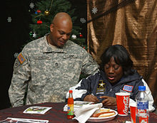 Sheryl Underwood with a soldier at Camp Arifjan, Kuwait, December 12, 2007, as a part of the Sgt. Maj. of the Army's Hope and Freedom tour to entertain deployed troops. Sheryl Underwood Kuwait.jpg