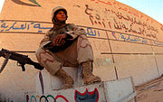 IRAQ - Lance Cpl. John A. Marcogliese of MASS-3 stands guard at one of several Olympic stadiums in Baghdad during the 2003 invasion of Iraq. OlympicPark.jpg