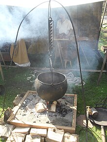 Replica of a Viking cooking-pot hanging over a fire Viking-style cooking pot.jpg