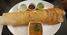 Dosa with chutney and sambar with sauteed potato filling in a restaurant dvsh.jpg