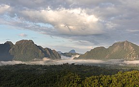 Sunny mist in the mountains at golden hour, South-West view from Mount Nam Xay, Vang Vieng, Laos