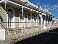 broad columned porches and balconies painted in the tasty lime colors on Calle Reina #118