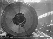 Woman cleaning the rifling of a 15-inch howitzer WomanCleaning15inchGunRiflingCOW.jpg