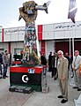 Image 34Ambassador Cretz Stands by Fist Crushing a U.S. Fighter Plane Sculpture which was captured after the fall of Tripoli (from Libya)