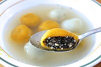 A bowl of tangyuan with black sesame filling. Yellow ones have skins made with pumpkin. Pumpkin tangyuan (Tang Yuan ) with red bean baste and black sesame fillings.jpg