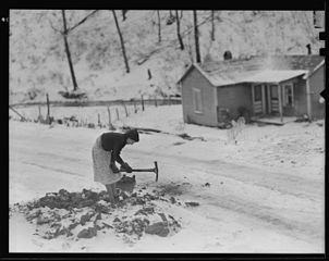 Woman gathering coal