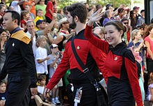 People wearing Star Trek: the Next Generation uniforms in a parade.