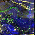 False color DMSP image looking down from 850 km altitude showing discrete aurora (yellow) north of Scandinavia, clouds and fog are blue