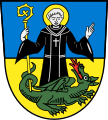 Gemeinde St. Mang geteilt in Blau und Gold, darin der Gemeindepatron St. Magnus mit Abtsstab und besiegtem Drachen.