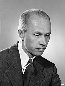 Head and shoulders of middle-aged man in suit and tie