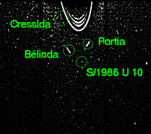 Foto de Hubble montranta S/1986 U 10 apud Kresido, Porcio kaj Belindo