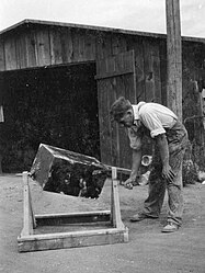 Mixing "Paris green" and road dust preparatory to dusting streams and breeding places of mosquitoes during World War II