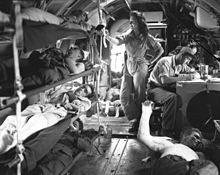 A U.S. C-46 aircraft conducting an aerial evacuation of wounded American troops from Manila, the capital of the Philippines, shortly after U.S. forces retook the city after intense fighting with the Japanese. C-46 medical flight.jpg