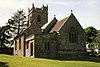 Stone building with square tower.