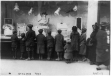 Children gazing through Macy's window in New York City in the early 20th century Christmas toys I.png