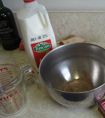 Instant chocolate pudding mix, milk and a measuring cup Instant pudding mix and milk.jpg