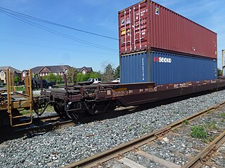 A 53-foot well car also fitted with a fifth-wheel coupling to allow semi-trailer transport as well