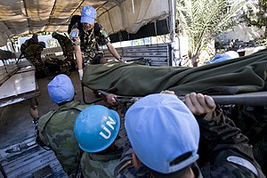 MINUSTAH members loading an injured person aboard a lorry