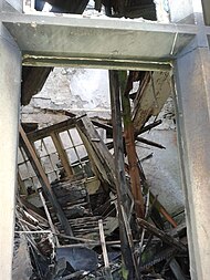 Showing current extent of dereliction with floor joists and window frames collapsed