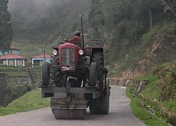 A road-roller powered by a tractor mounted on it
