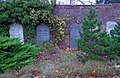 semi-circular brick wall, left side with gravestones