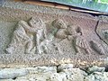 Workers prepare mortar in a trough.