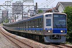 Silver train with blue and white accents on the front-end and body