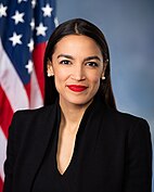 Woman in a red lipstick standing in front the US flag