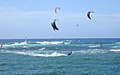 Kite surfing on O‘ahu in Hawai‘i with wind-surfer catching the wave break