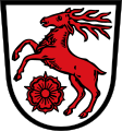 Gemeinde Kümmersbruck In Silber ein springender roter Hirsch, darunter vorne eine rote heraldische Rose.