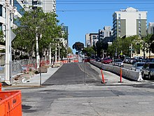 An urban arterial with construction work occupying half the roadway