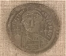 picture of a 6th century bronze coin with the image of Justinian I on it