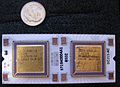 Top side of J-11 microprocessor hybrid. DC335 control chip on left, DC334 data path chip on right. US dime for scale.