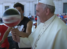 Pope Francis spinning a basketball on a pencil