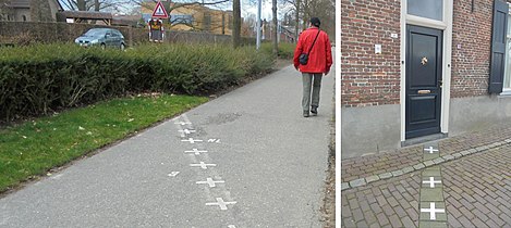 Sidewalk marking Belgium-Netherlands border.