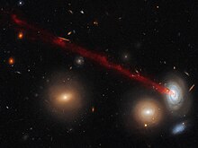 Tails in spiral galaxy D100, found in the Coma Cluster, are created by ram-pressure stripping. Wading through water.jpg