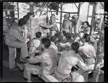 IN A READY ROOM ON BOUGAINVILLE, Marine fighter pilots gather around their flight leader to get some last minute pointers before they take off on a bomber escort mission against Rabaul. 127-N-77863.tif