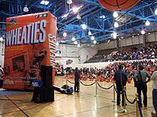 A blow-up model of a Wheaties box to commemorate the opening of Glory Road on the UTEP campus, November 29, 2005. 1966 NCAA basketball championship team members Willie Worsley and Nevil Shedd, are pictured on the box, cutting down the hoop net. Wheaties cheerleaders.jpg