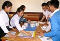 Image 7Students using dice to improve numeracy skills. They roll three dice, then use basic math operations to combine those into a new number which they cover on the board. The goal is to cover four squares in the row. (from Game)