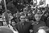 A large crowd of predominantly black people are seen on the march.